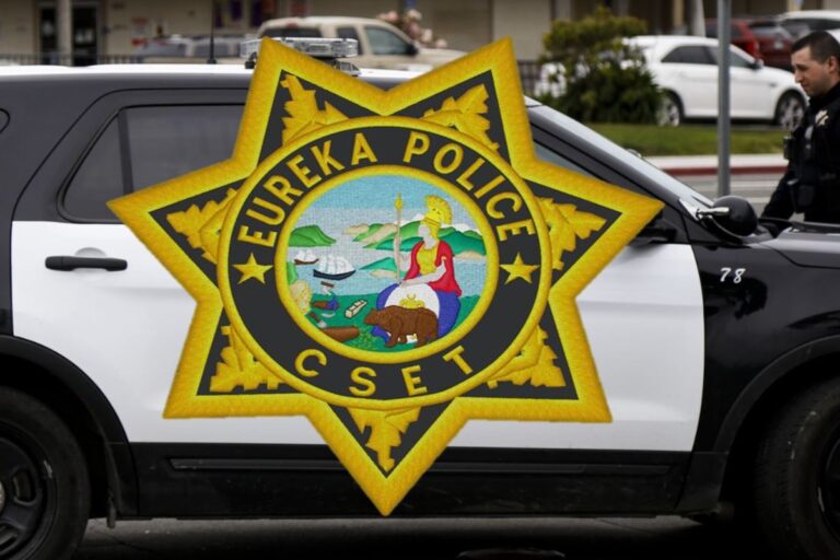 black and white police suv partially visible in photo with a eureka police cset badge imposed over the image covering the door in the photo