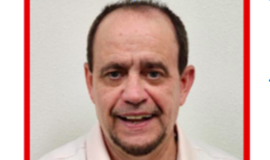 Picture of middle aged man with groomed goatee, smiling in a head shot photo