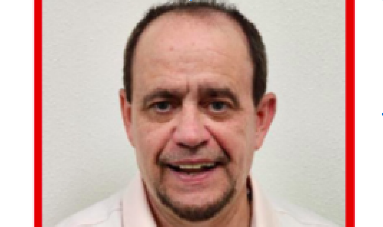 Picture of middle aged man with groomed goatee, smiling in a head shot photo