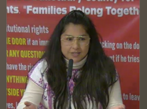 woman speaking in front of a microphone