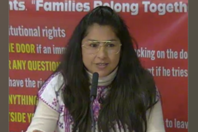 woman speaking in front of a microphone
